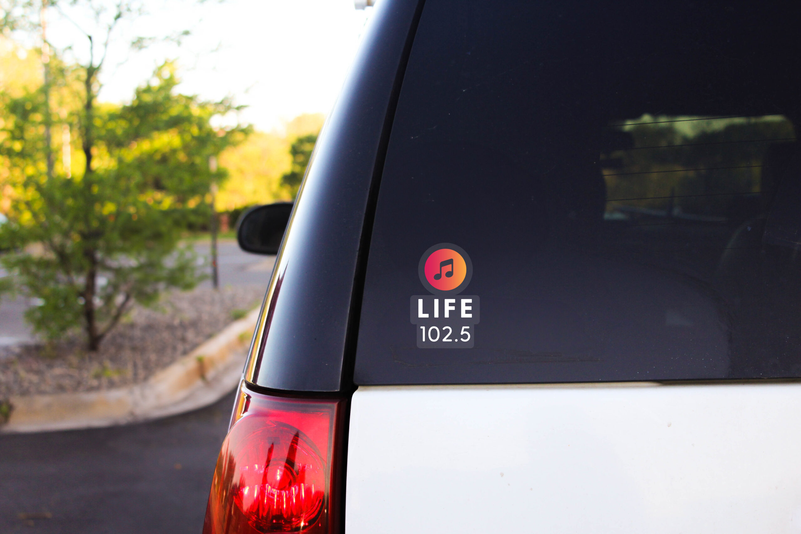 Life 102.5 sticker on the back of a car.